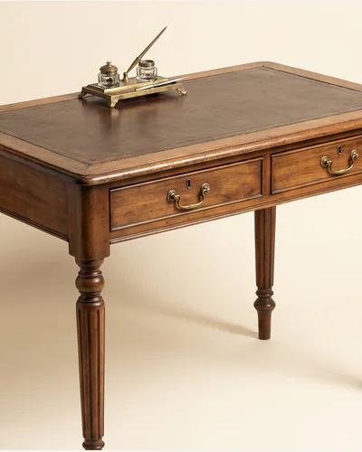 A Regency mahogany library table on turned and reeded legs with brass castors. — the legs.