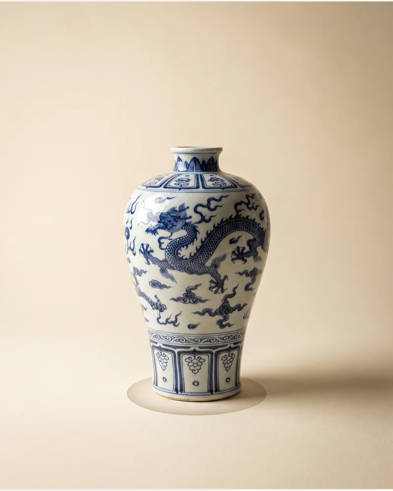 A blue and white porcelain baluster vase photographed on a warm paper plate.